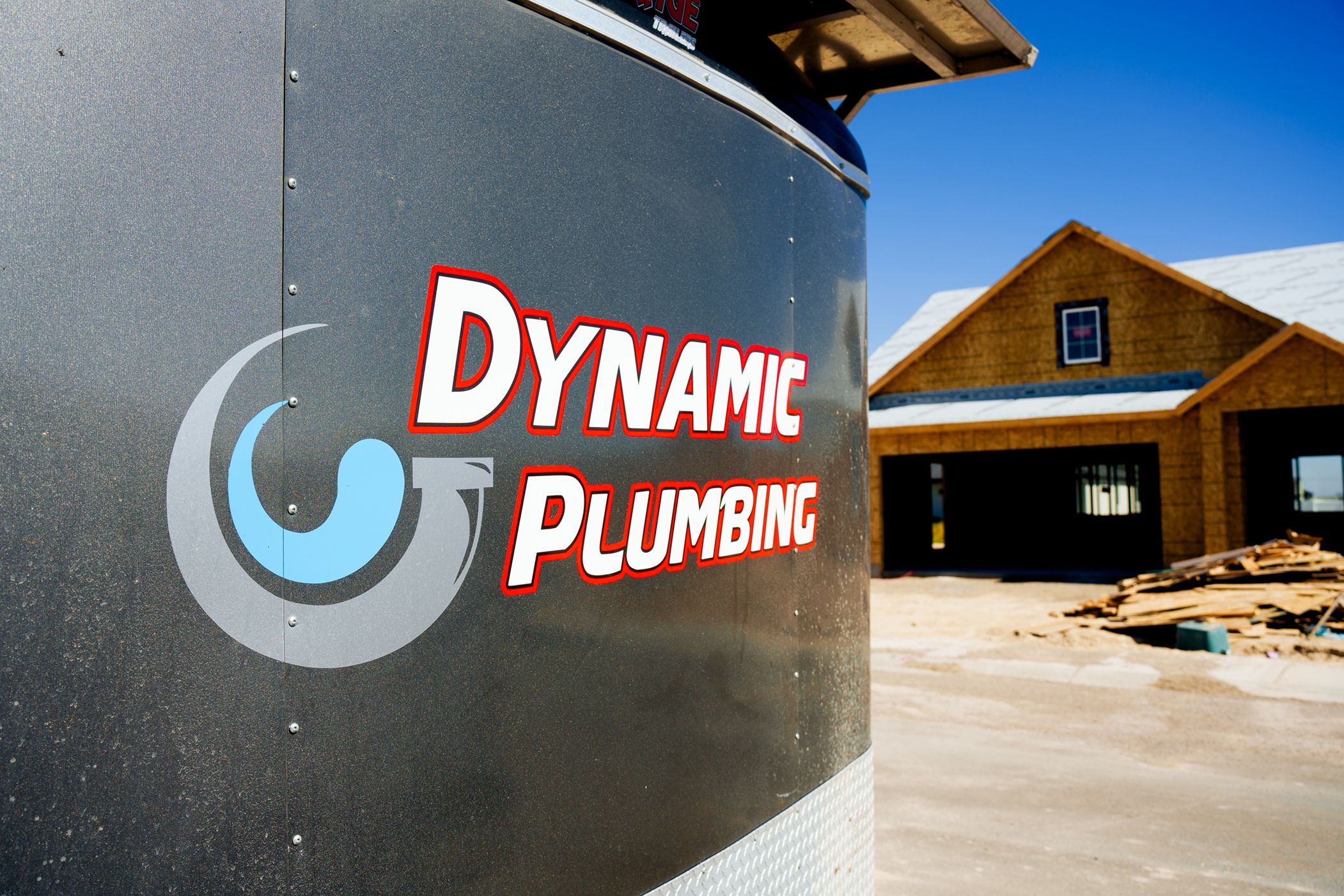 Dynamic Plumbing Trailer outside of a house being built