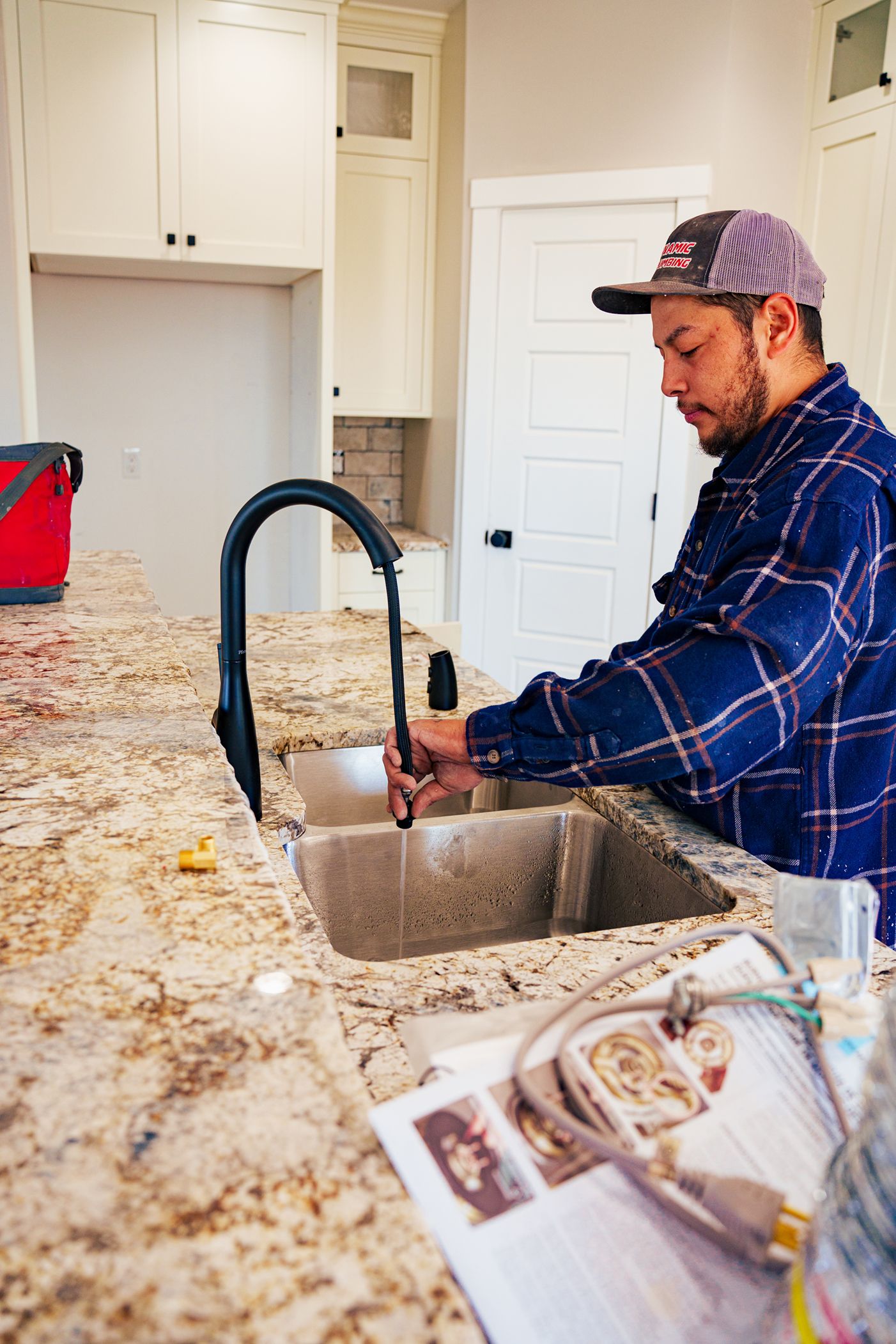 Man working on installing a new sink in a home